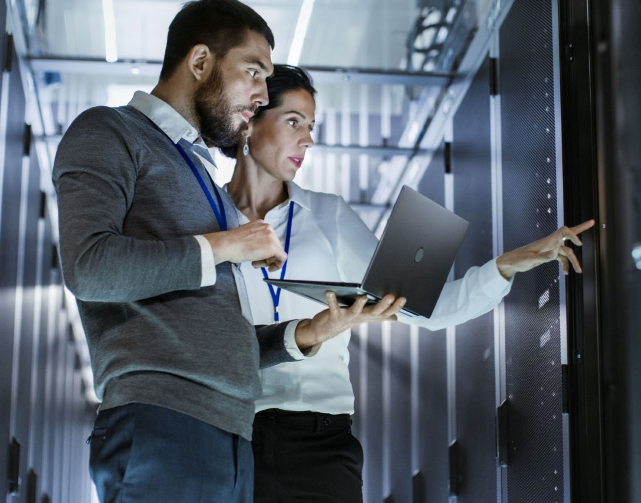 2 people in data center with a computer