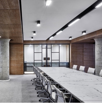Recessed Lighting in board room with marble table and white chairs