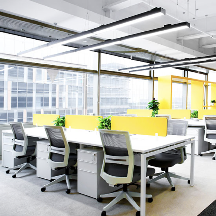 Office space with a large white table and chairs with yellow accents
